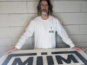 Jeff Hayward holding a sign for MIIM Horticulture.